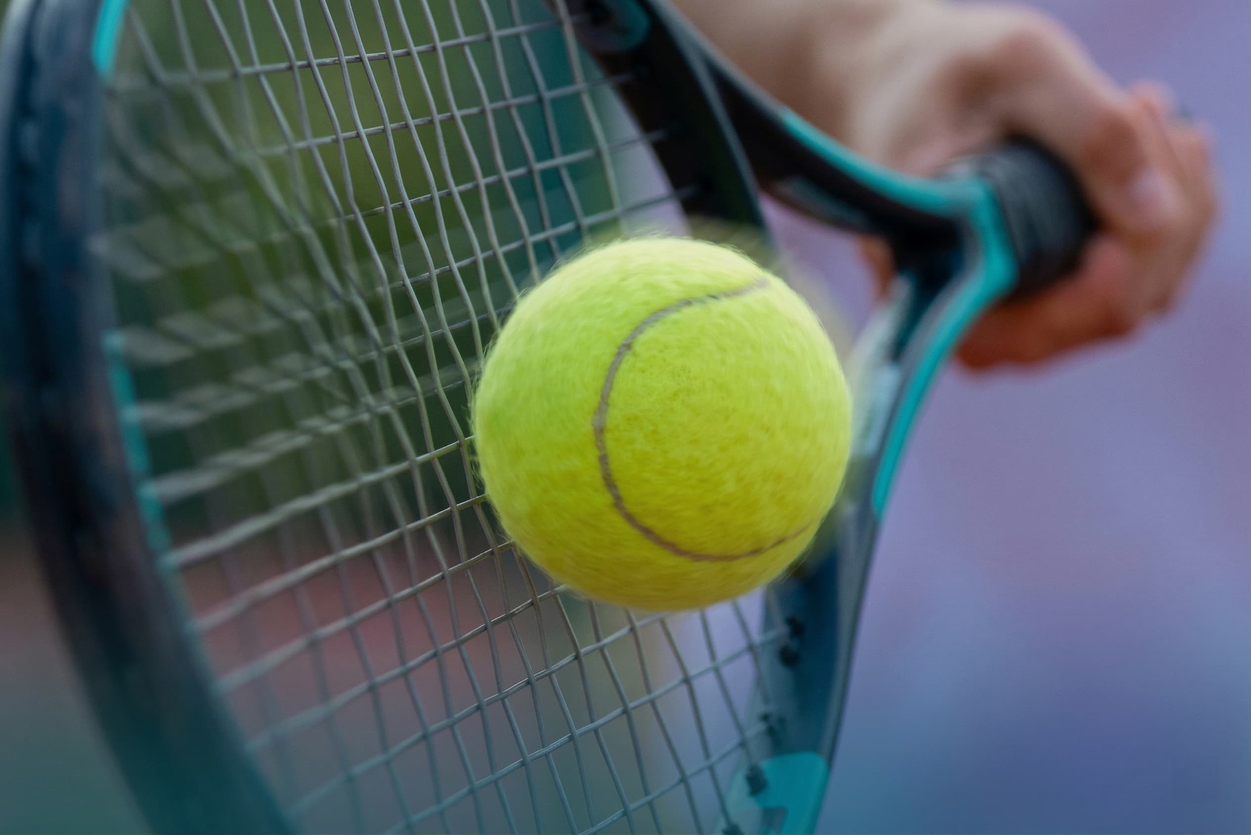 Tennis racket and ball on court